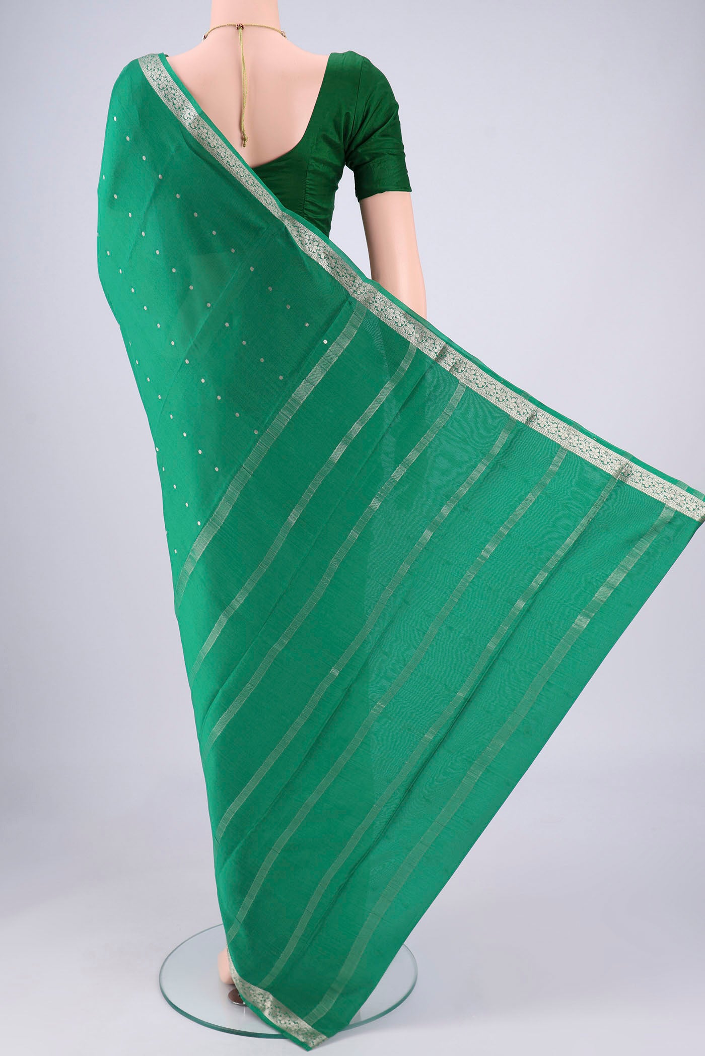 Flat view of Green Mysore Crepe Saree with Zari Butta on the body and Zari Border. 