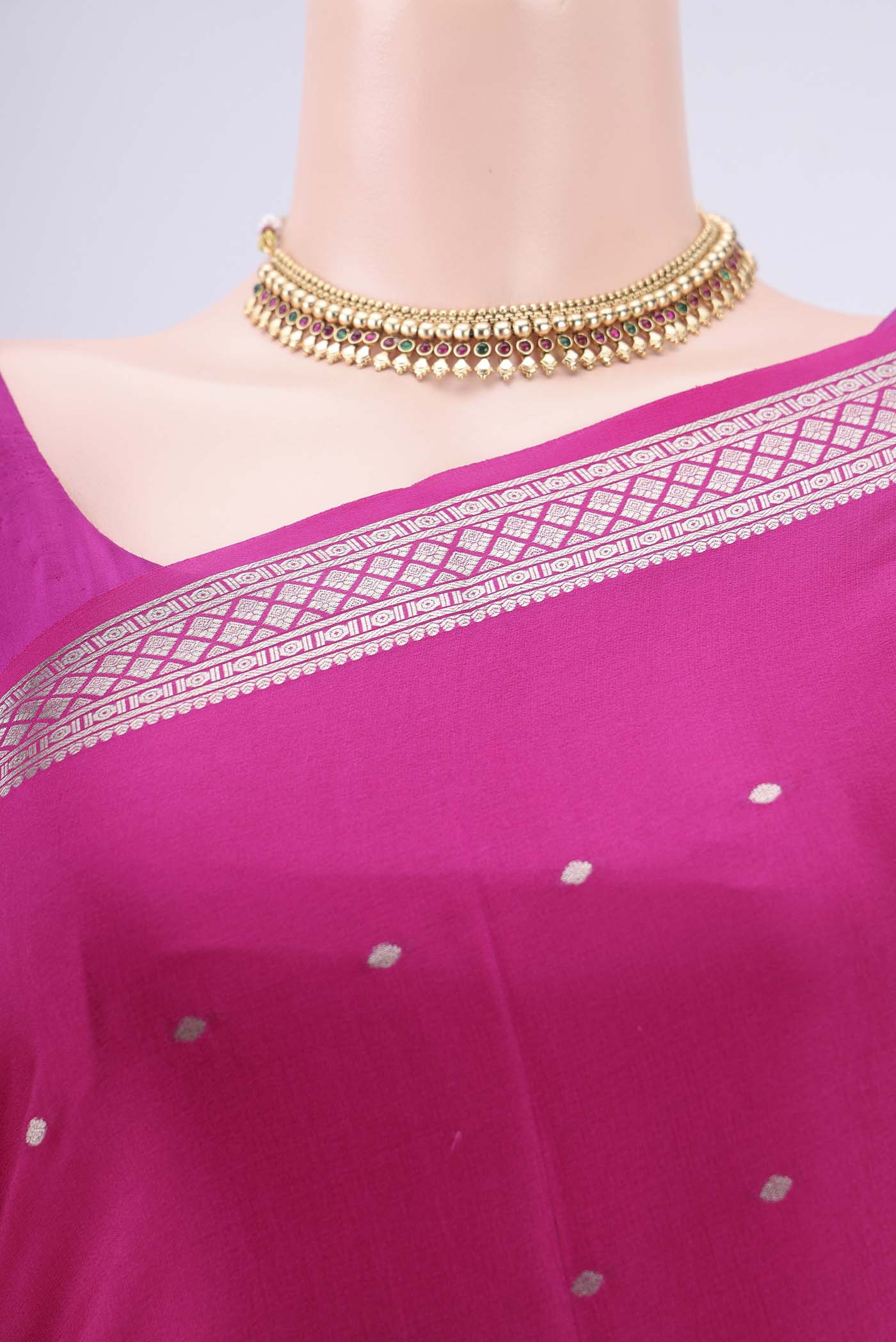 Border image of Rani Pink Mysore Crepe Saree with Zari Butta on the body and Zari Border. 
