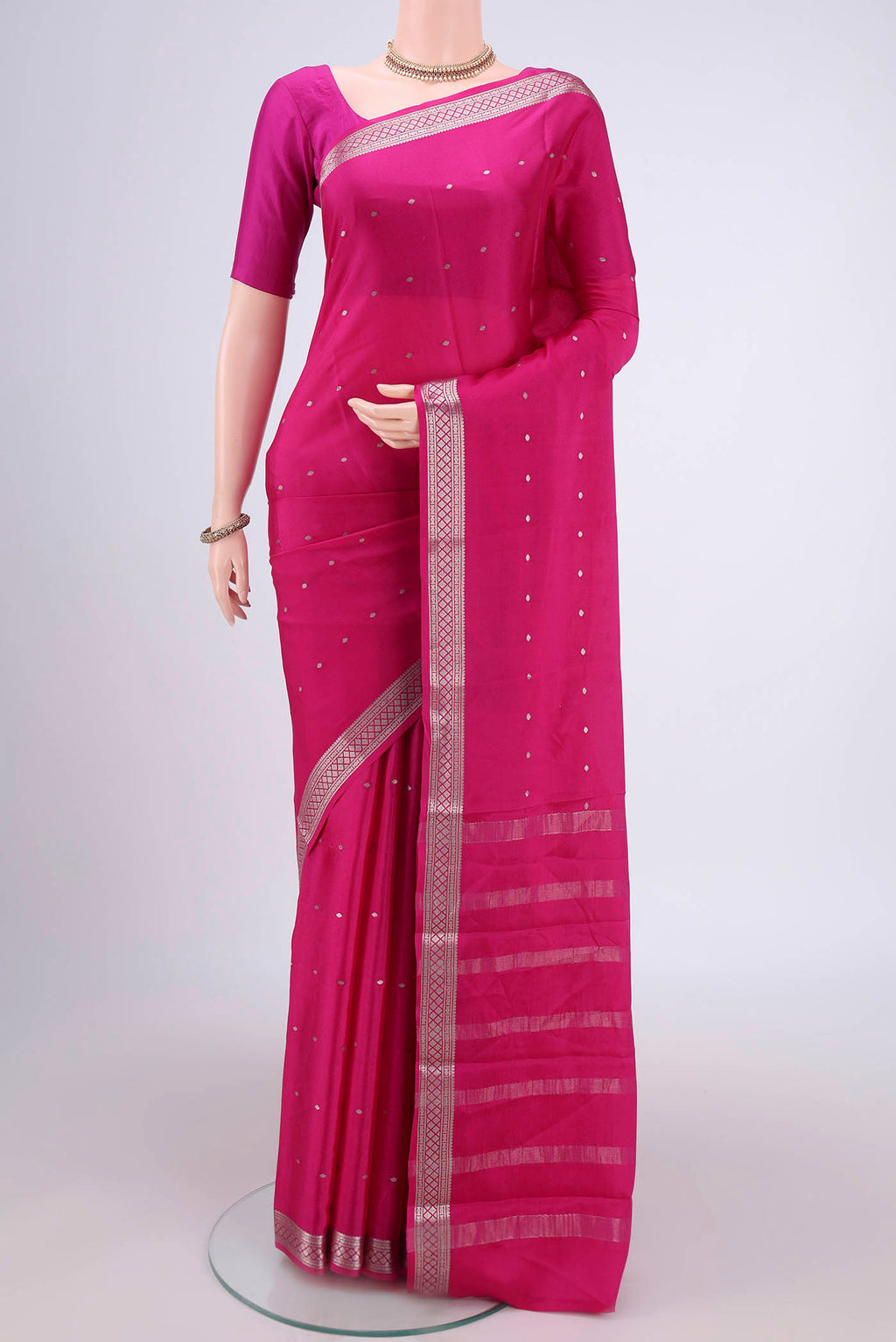 Rani Pink Mysore Crepe Saree with Zari Butta on the body and Zari Border.  displayed on a mannequin