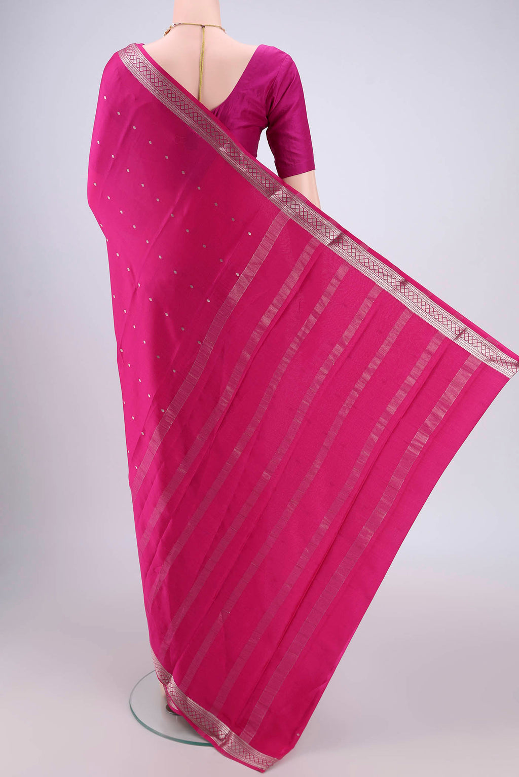 Flat view of Rani Pink Mysore Crepe Saree with Zari Butta on the body and Zari Border. 