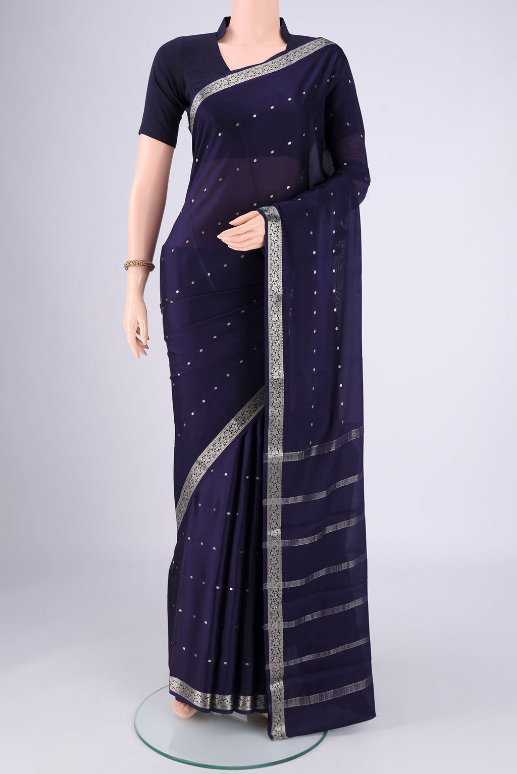 Navy Blue Mysore Crepe Saree with Zari Butta on the body and Zari Border.  displayed on a mannequin