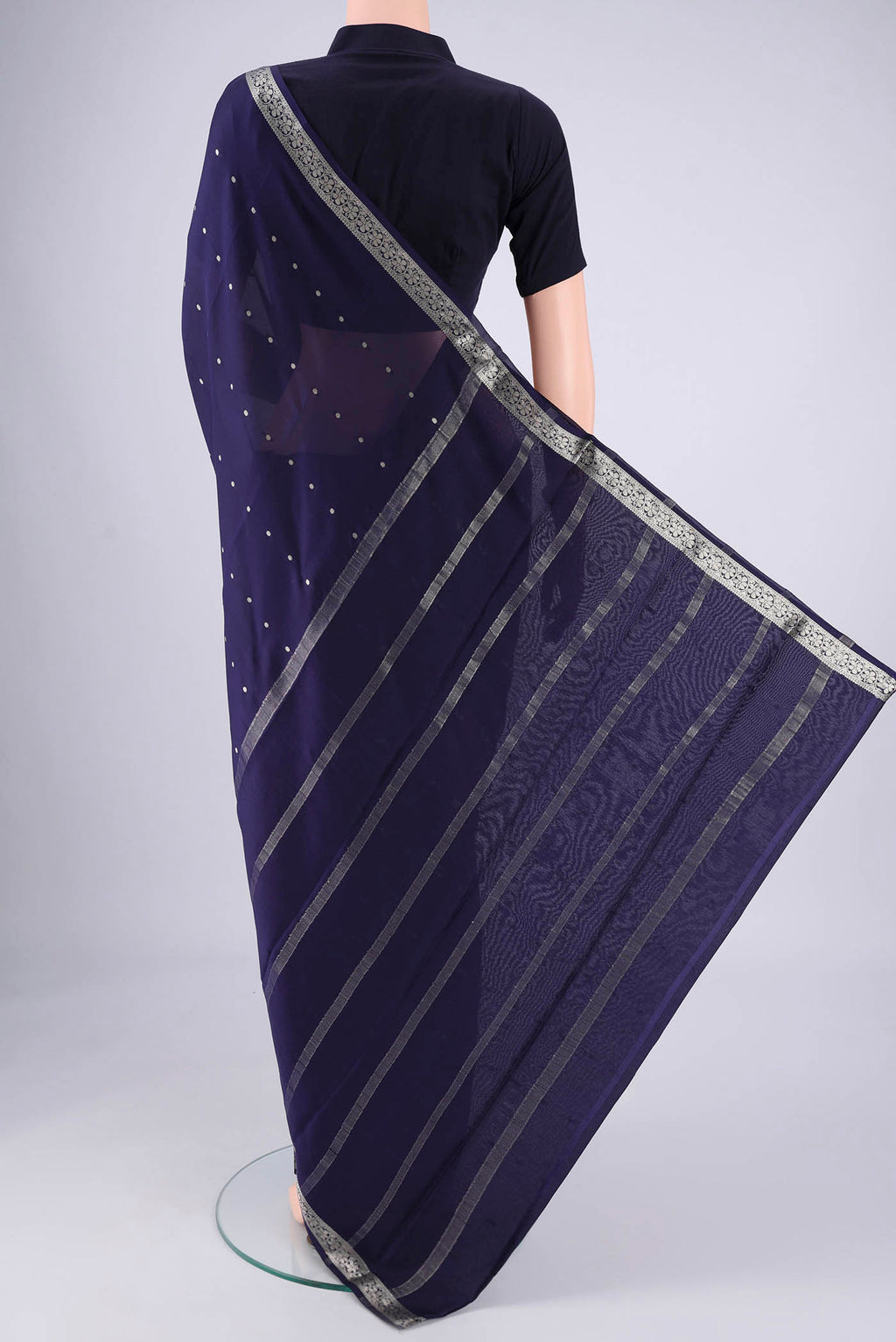 Flat view of Navy Blue Mysore Crepe Saree with Zari Butta on the body and Zari Border. 