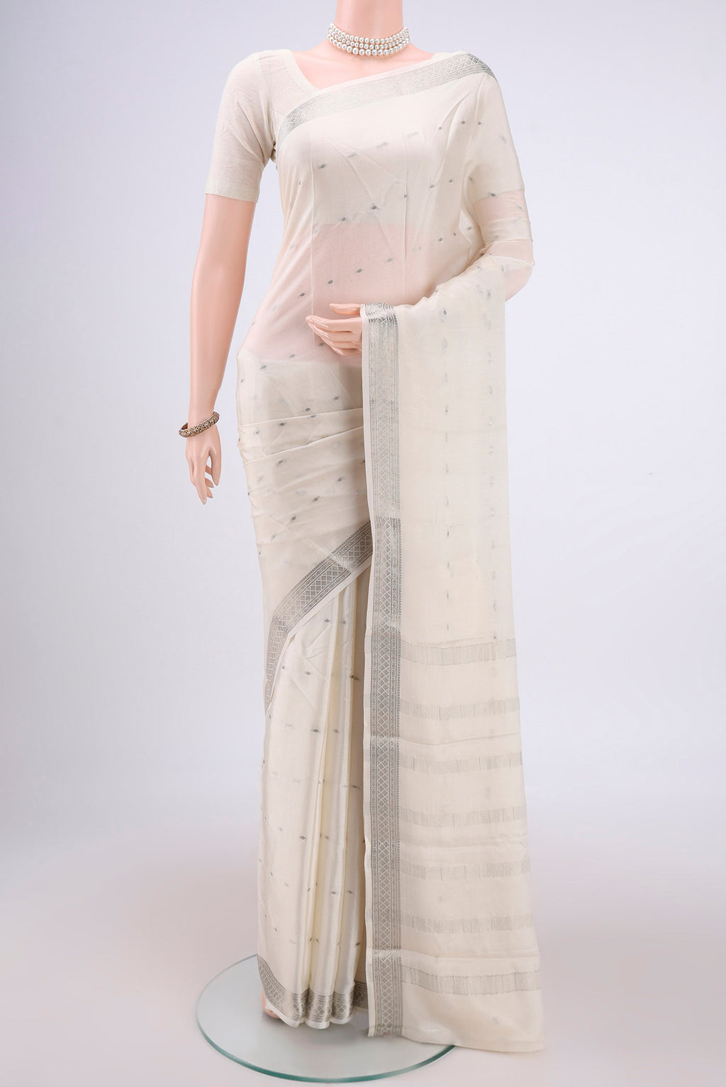 White Mysore Crepe Saree with Zari Butta on the body and Zari Border.  displayed on a mannequin