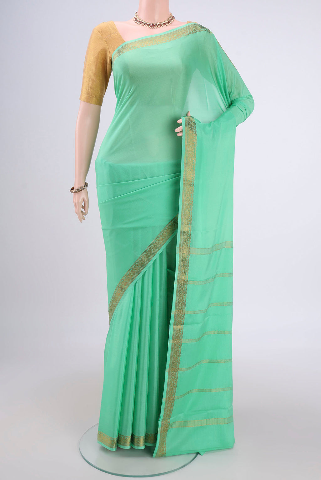 Mint Green Mysore Crepe Saree with Plain Body and Zari Border.  displayed on a mannequin