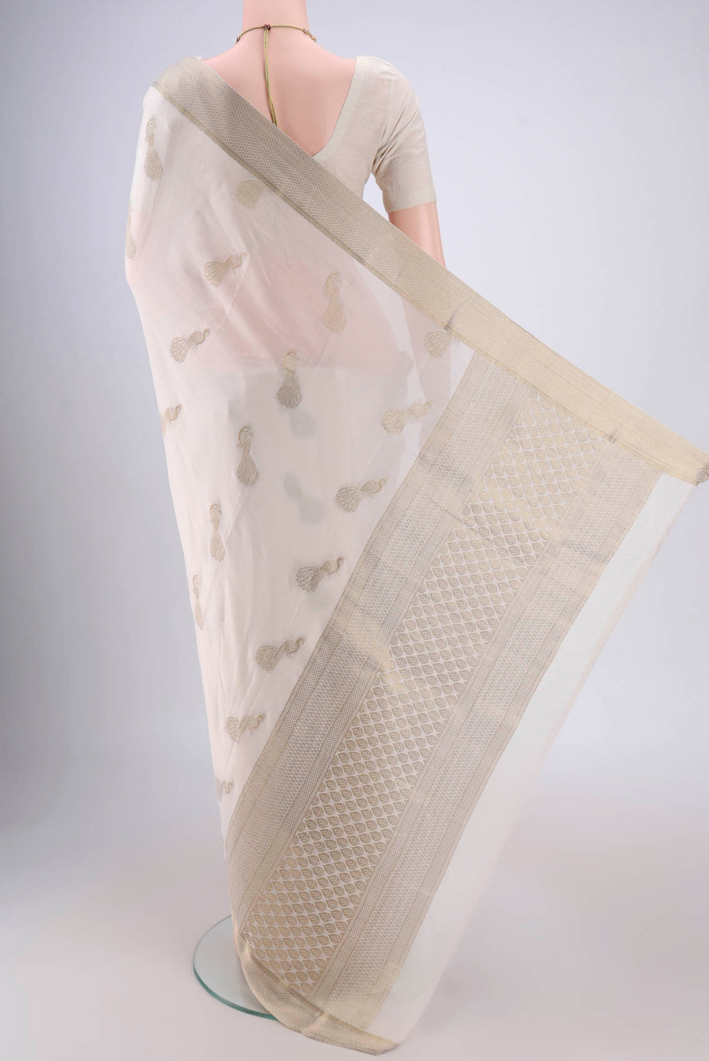 Flat view of Off White Mysore Crepe Saree with Zari Butta on the body and Zari Border. 