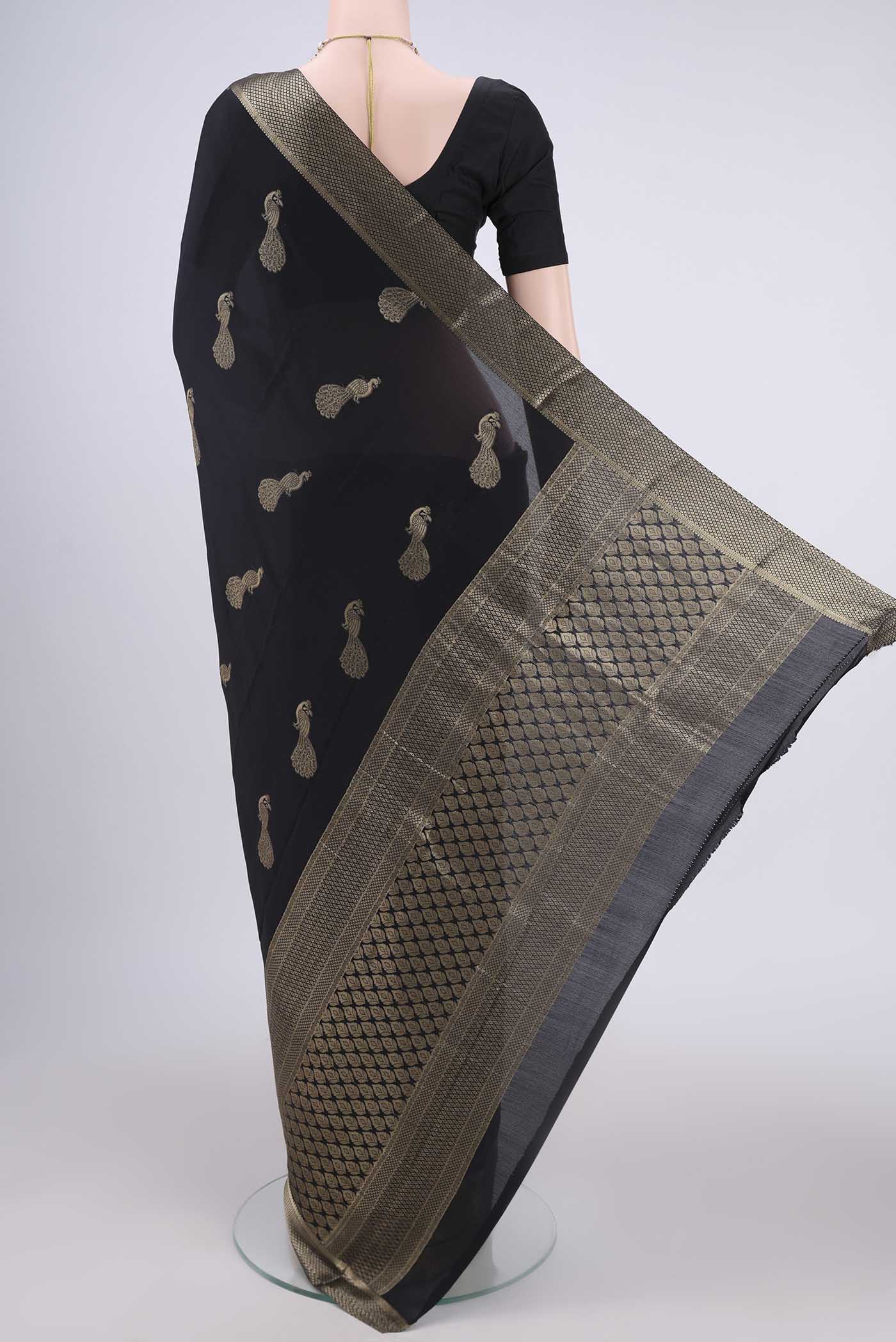Flat view of Black Mysore Crepe Saree with Zari Butta on the body and Zari Border. 