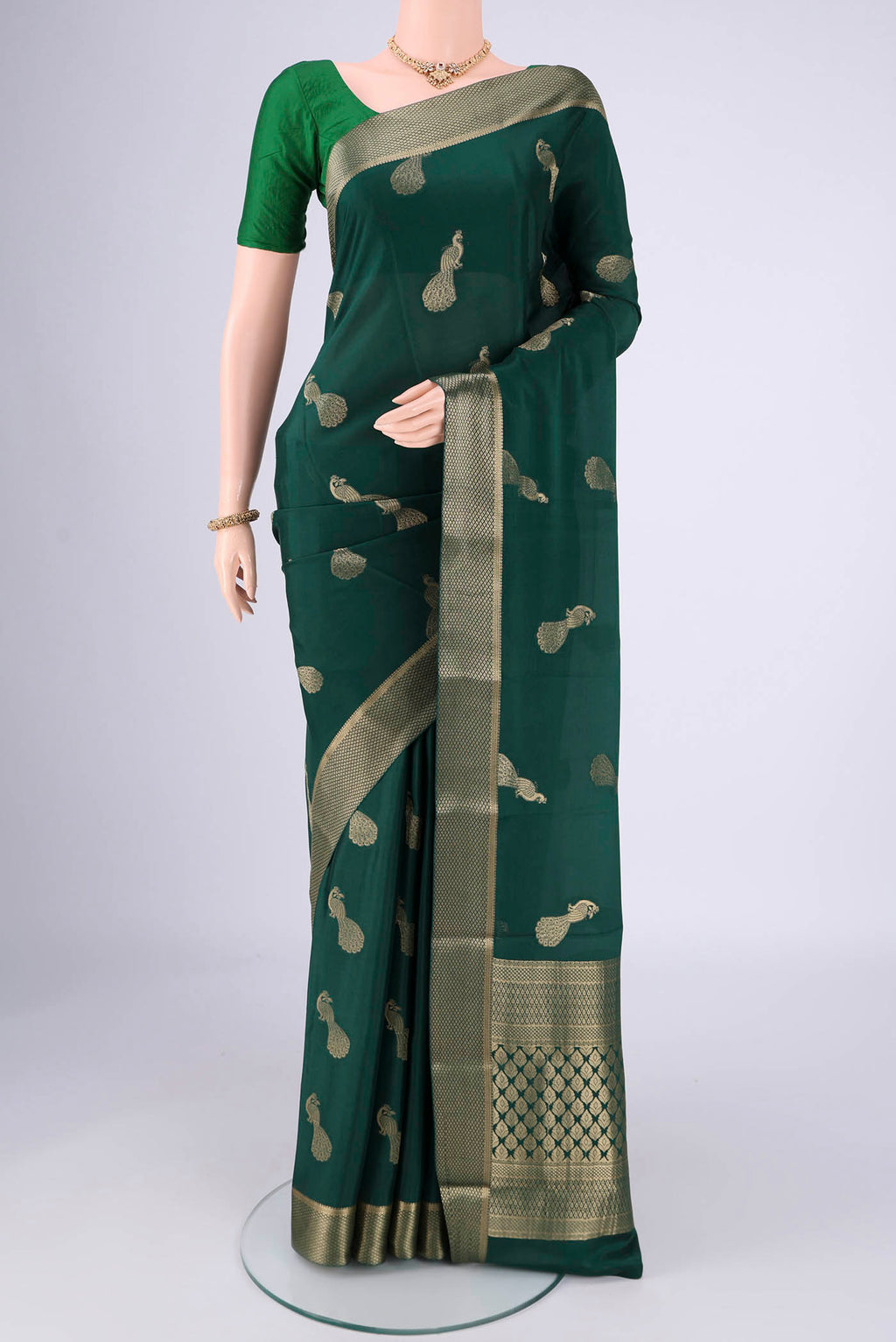 Bottle Green Mysore Crepe Saree with Plain Body and Zari Border.  displayed on a mannequin