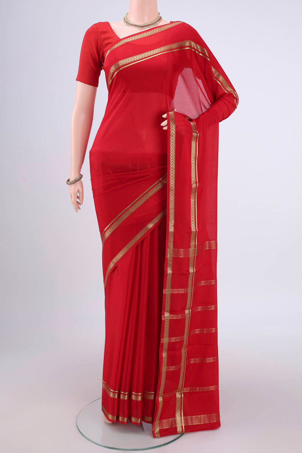 Red Mysore Crepe Saree with Plain Body and Zari Border.  displayed on a mannequin