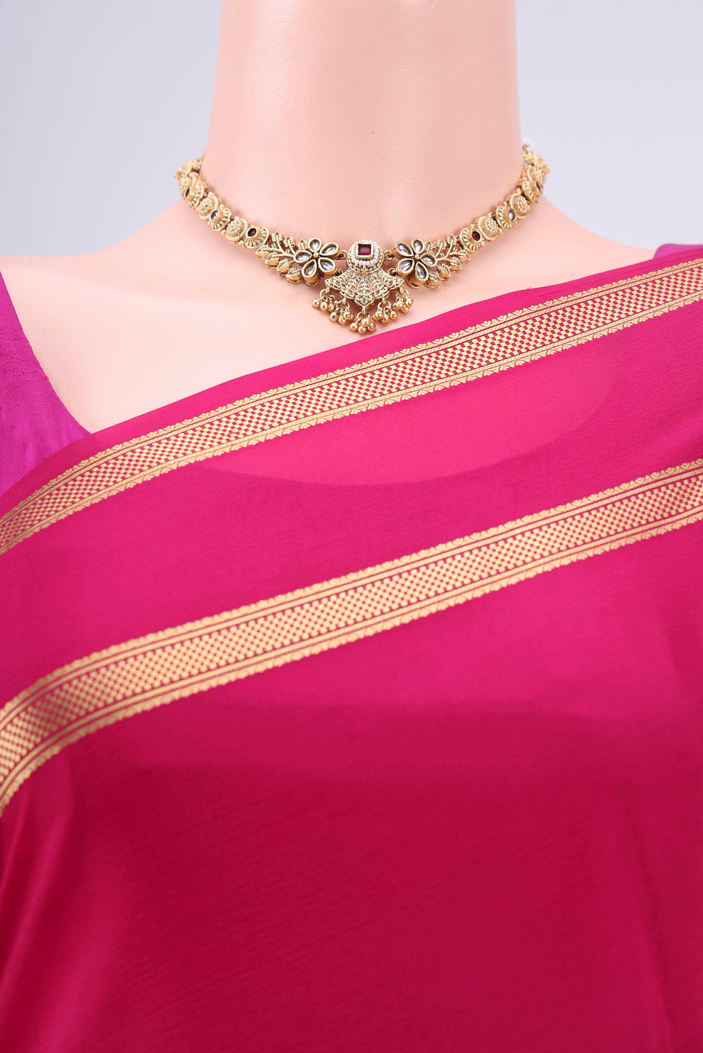 Border image of Rani Pink Mysore Crepe Saree with Plain Body and Zari Border. 
