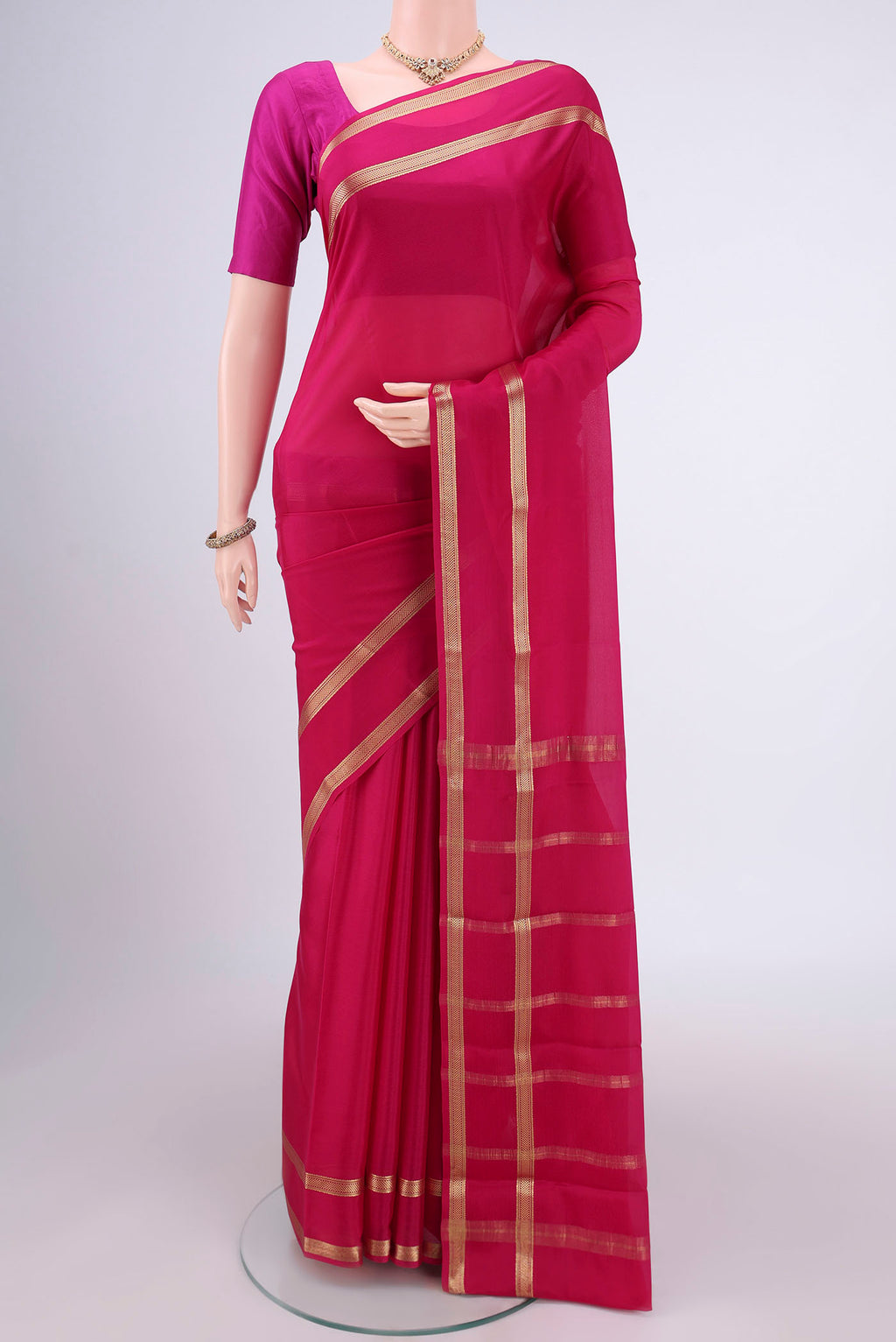 Rani Pink Mysore Crepe Saree with Plain Body and Zari Border.  displayed on a mannequin