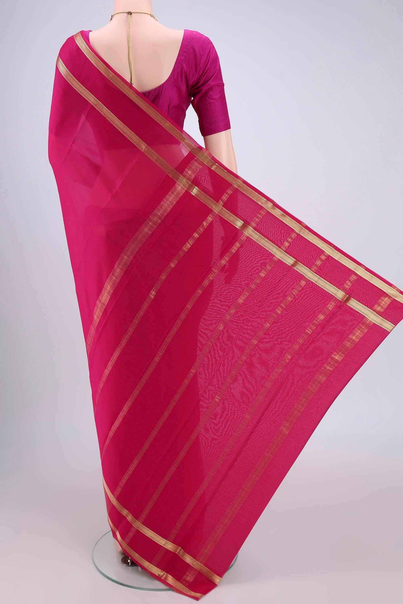 Flat view of Rani Pink Mysore Crepe Saree with Plain Body and Zari Border. 