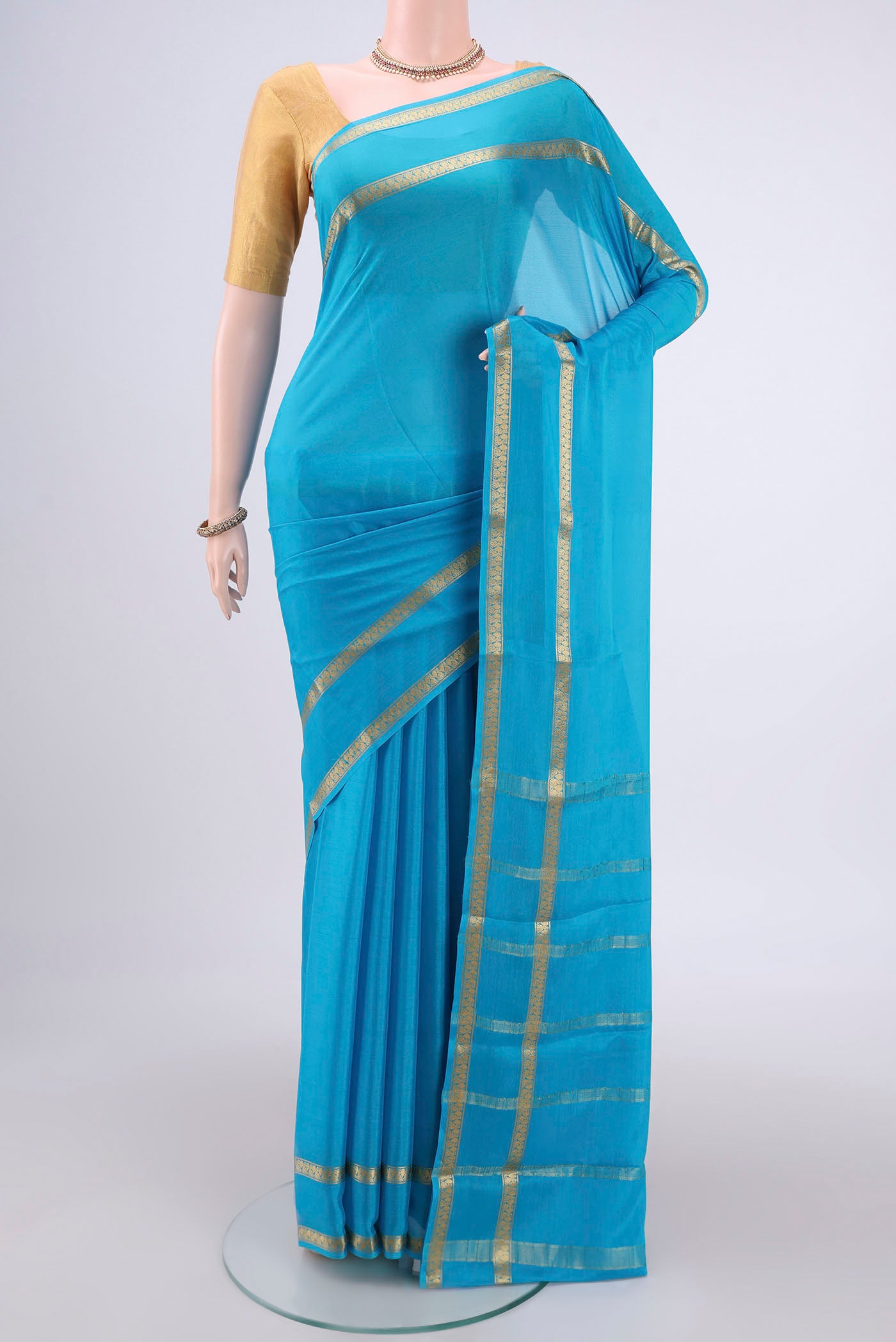Blue Mysore Crepe Saree with Plain Body and Zari Border.  displayed on a mannequin
