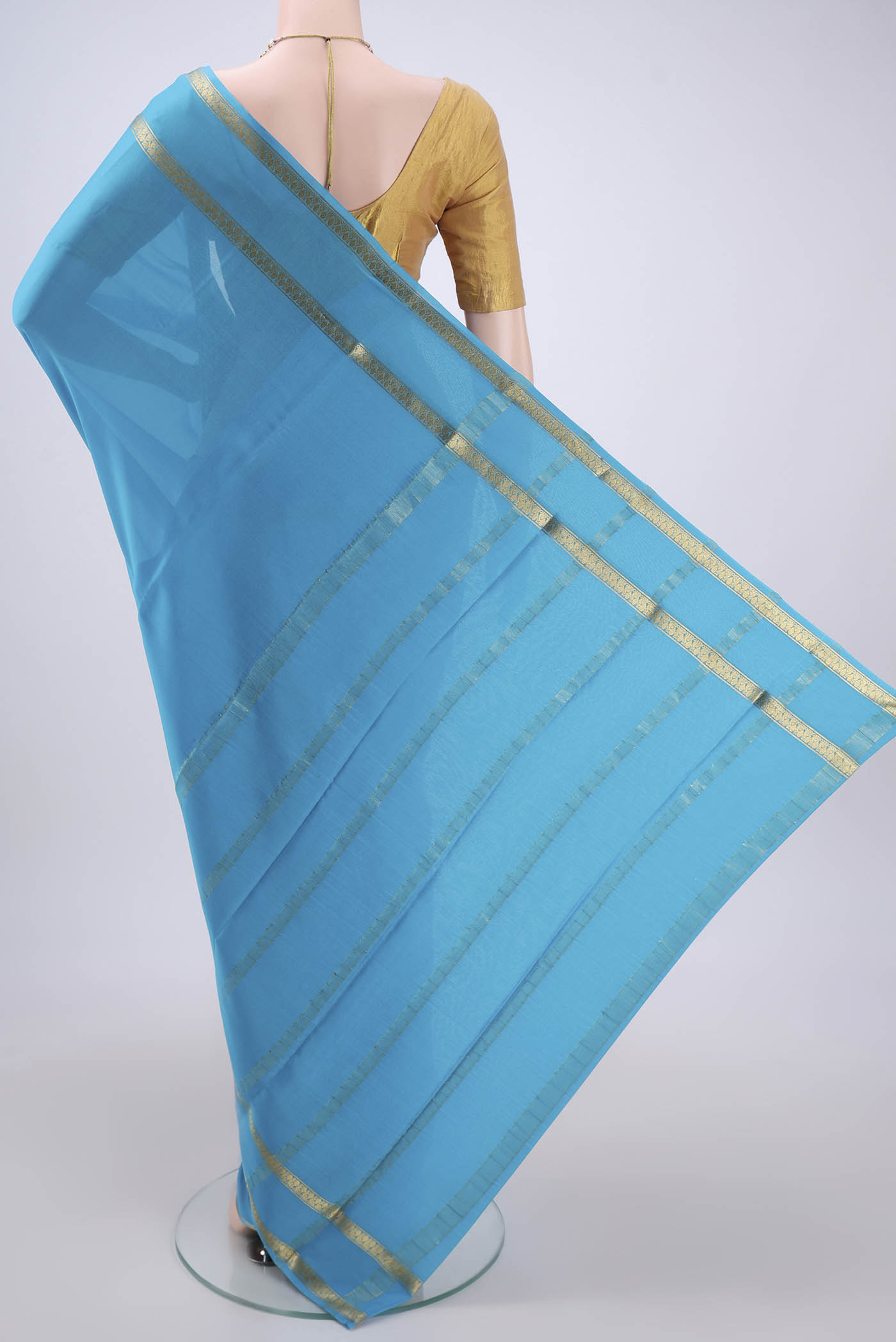 Flat view of Blue Mysore Crepe Saree with Plain Body and Zari Border. 