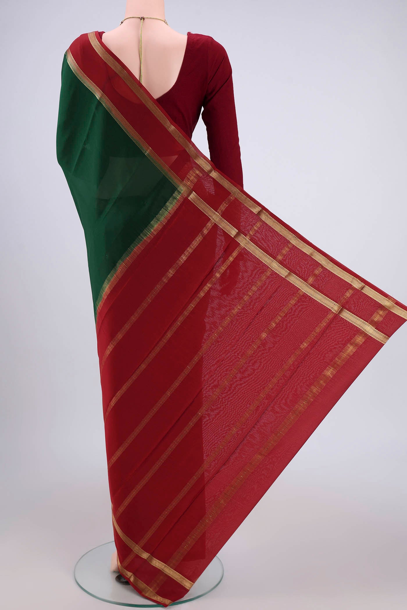 Flat view of Bottle Green Mysore Crepe Saree with Plain Body and Zari Border. 