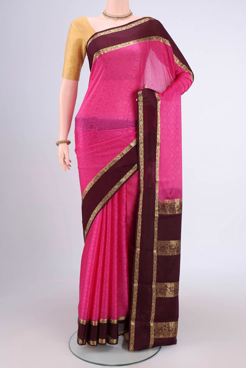 Rani Pink Mysore Crepe Saree with Jacquard design on the body and Zari Border.  displayed on a mannequin