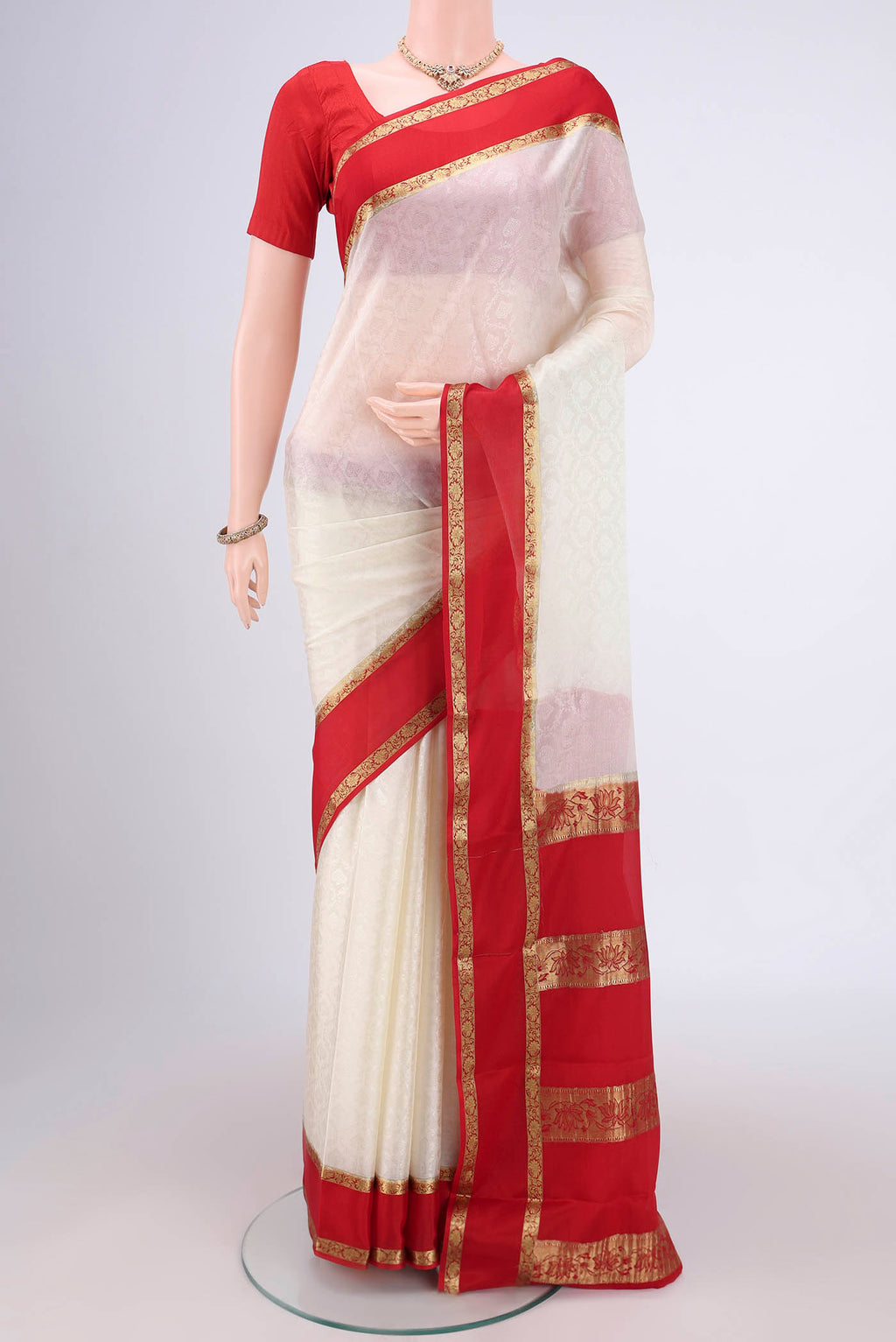 Off White Mysore Crepe Saree with Jacquard design on the body and Zari Border.  displayed on a mannequin