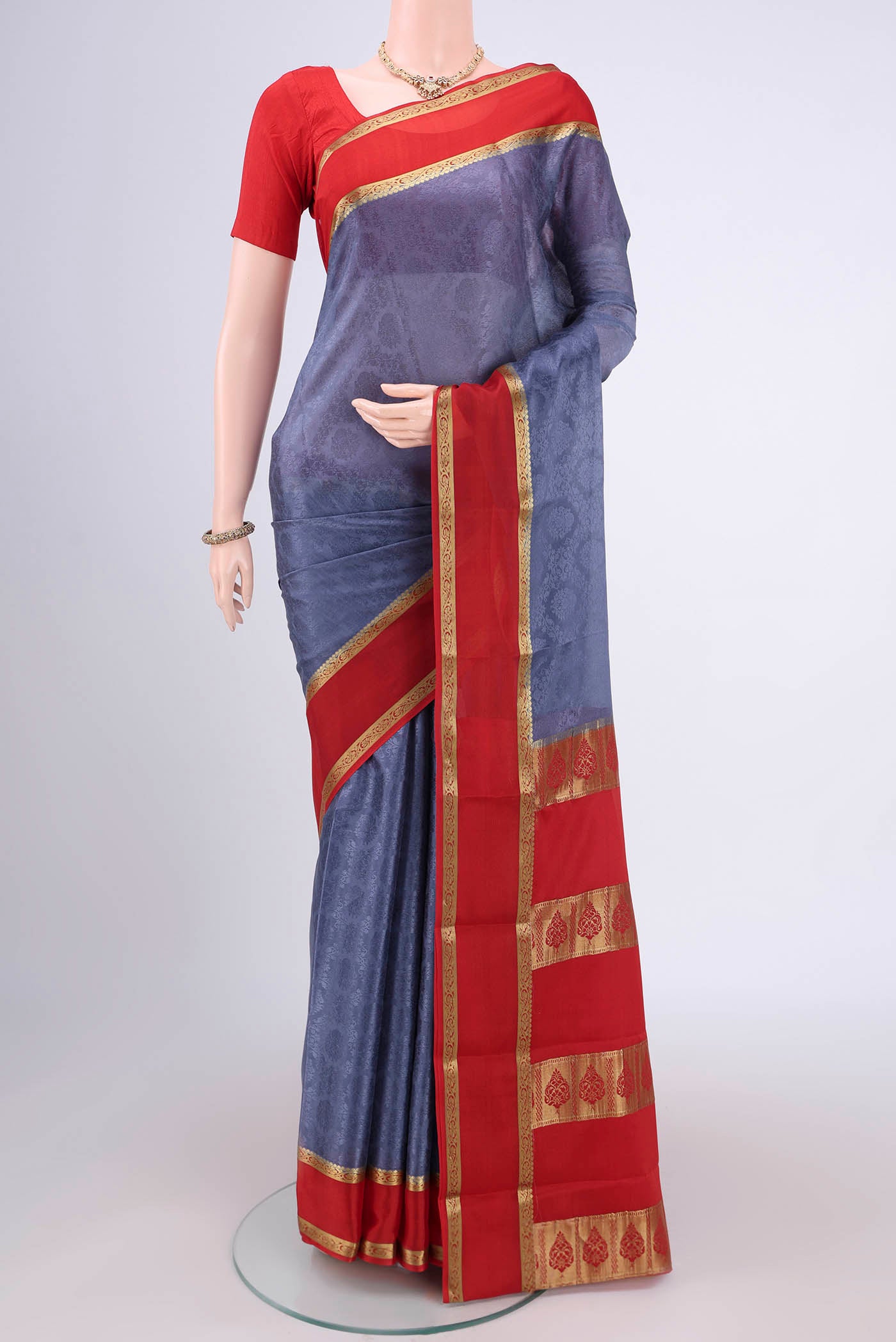Grey Mysore Crepe Saree with Jacquard design on the body and Zari Border.  displayed on a mannequin