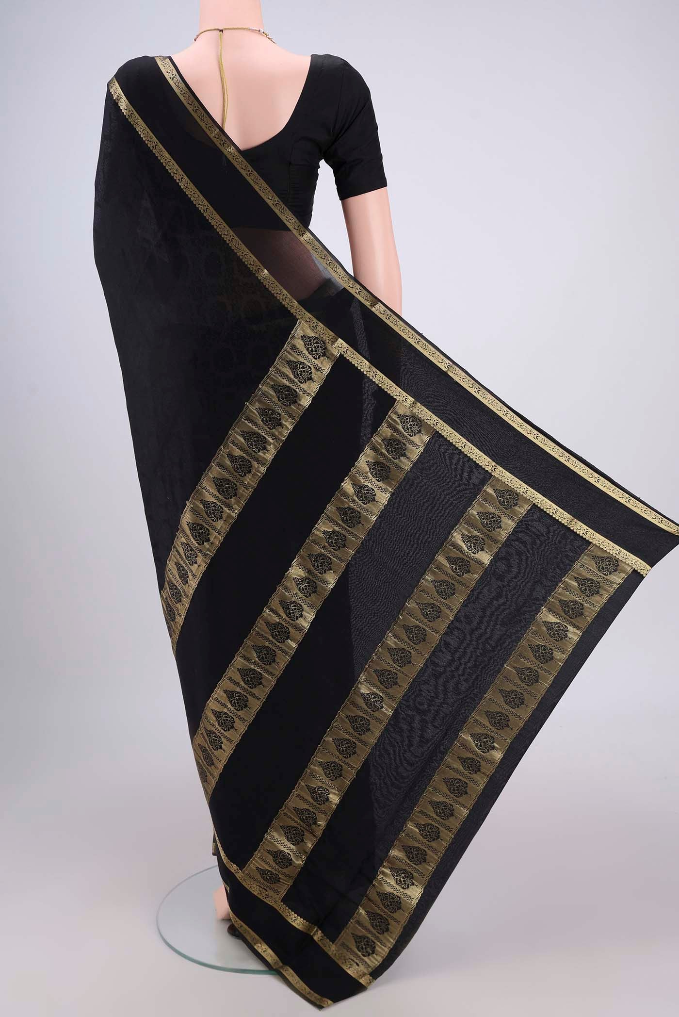Flat view of Black Mysore Crepe Saree with Jacquard design on the body and Zari Border. 