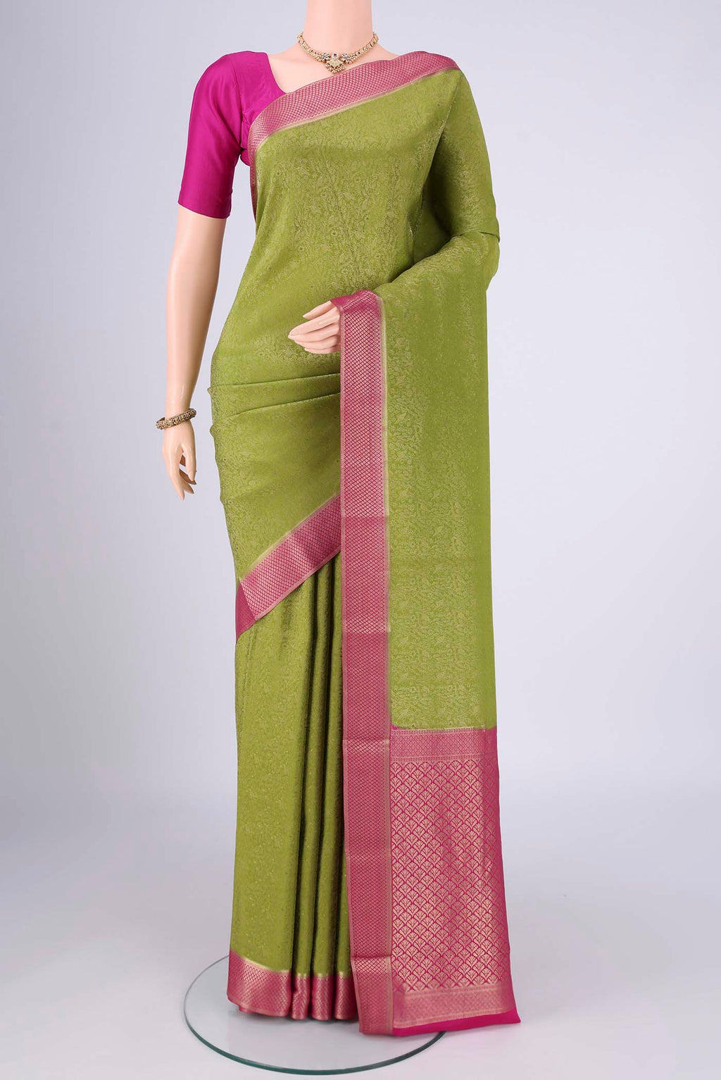 Green Mysore Crepe Saree with Zari Brocade on the body and Zari Border.  displayed on a mannequin