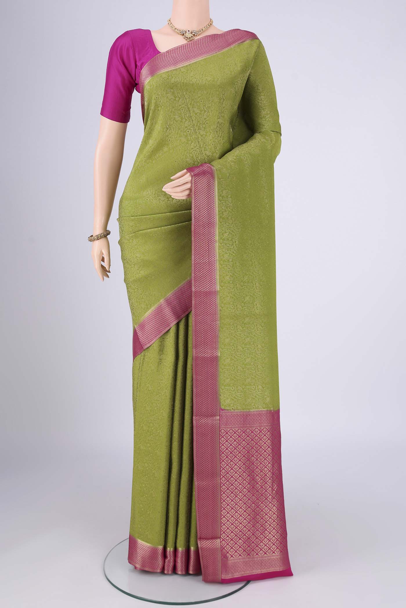 Green Mysore Crepe Saree with Zari Brocade on the body and Zari Border.  displayed on a mannequin