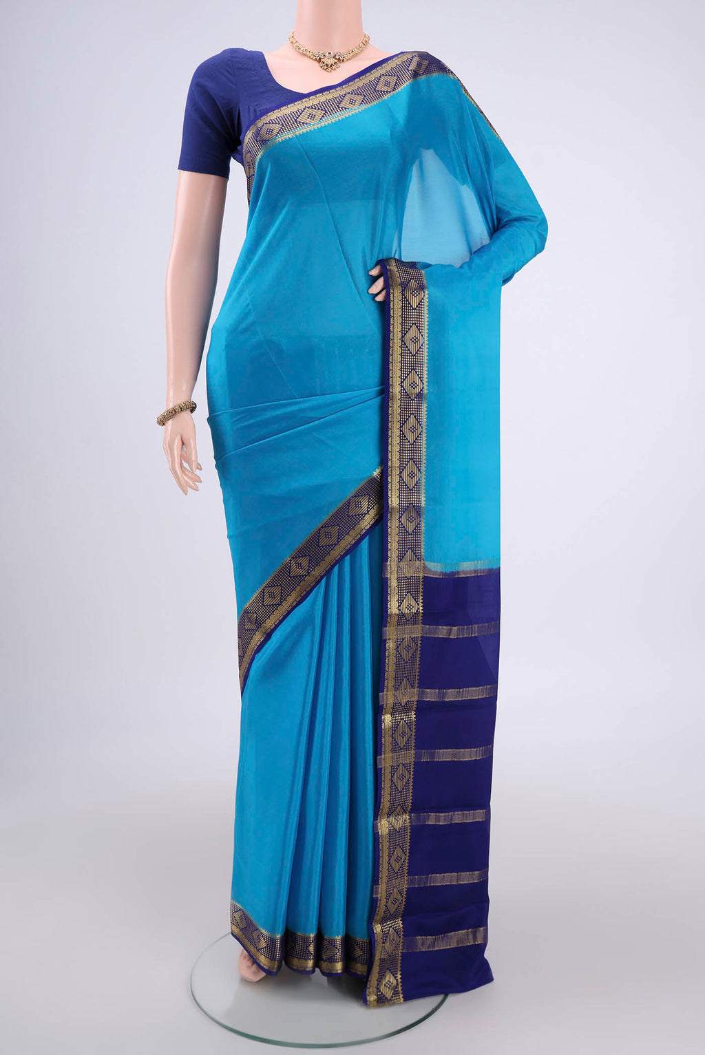 Electric Blue Mysore Crepe Saree with Plain Body and Zari Border.  displayed on a mannequin
