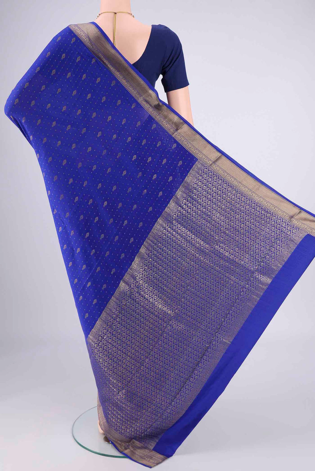 Flat view of Royal Blue Mysore Crepe Saree with Zari Butta on the body and Zari Border. 