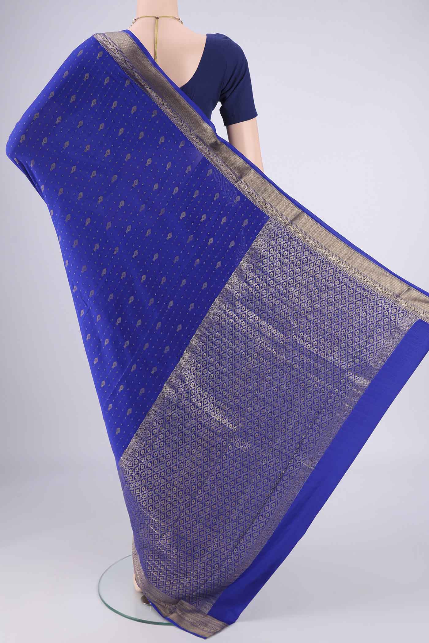 Flat view of Royal Blue Mysore Crepe Saree with Zari Butta on the body and Zari Border. 