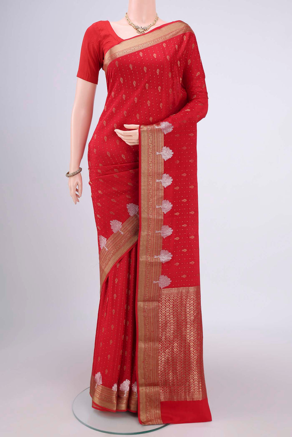 Red Mysore Crepe Saree with Zari Butta on the body and Zari Border.  displayed on a mannequin