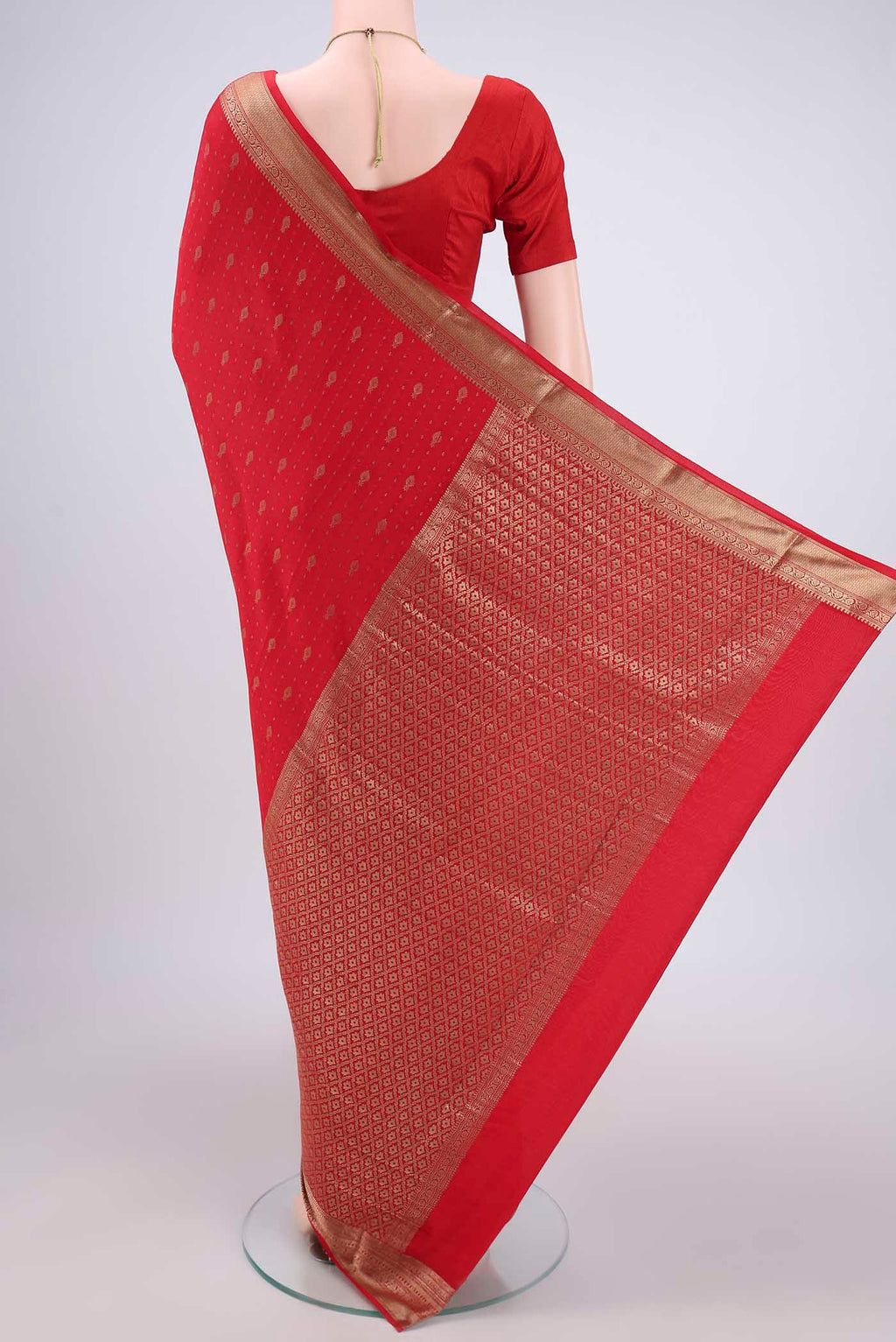 Flat view of Red Mysore Crepe Saree with Zari Butta on the body and Zari Border. 