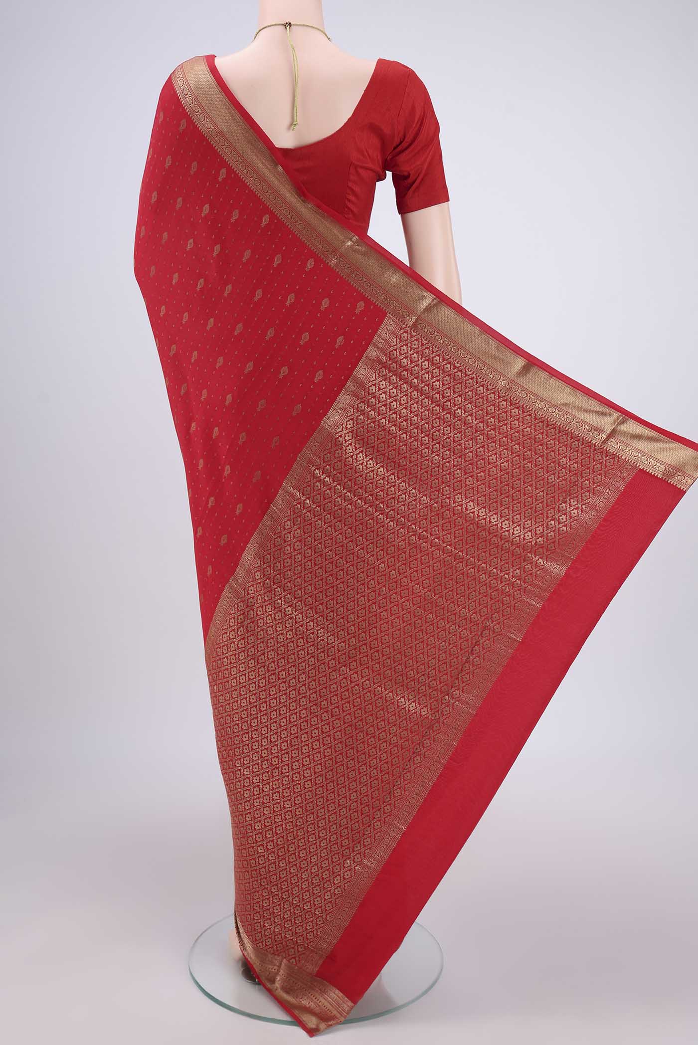 Flat view of Red Mysore Crepe Saree with Zari Butta on the body and Zari Border. 