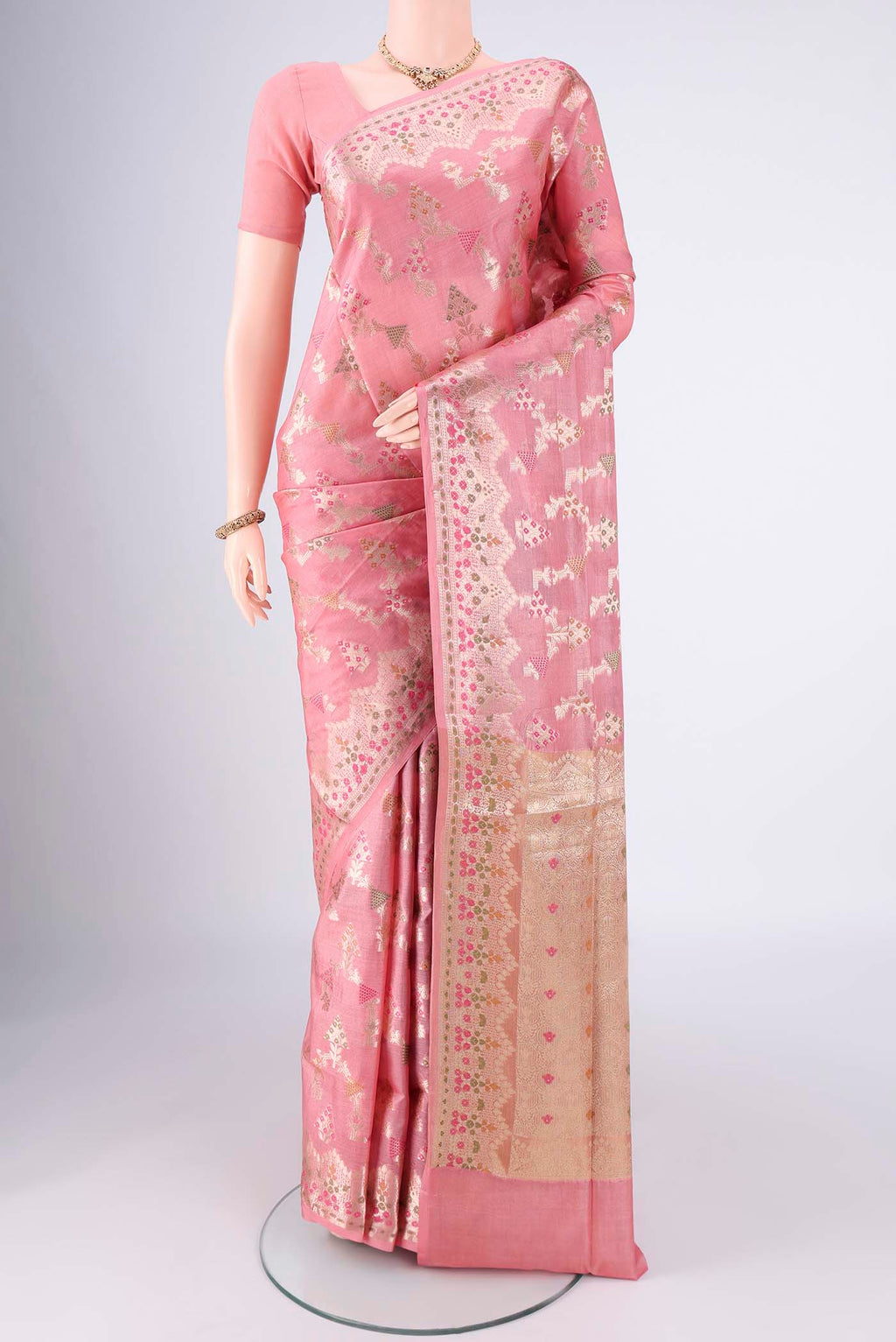 Peach Banarasi Tussar Silk Saree with Zari And Thread Butta on the body and Zari Border.  displayed on a mannequin