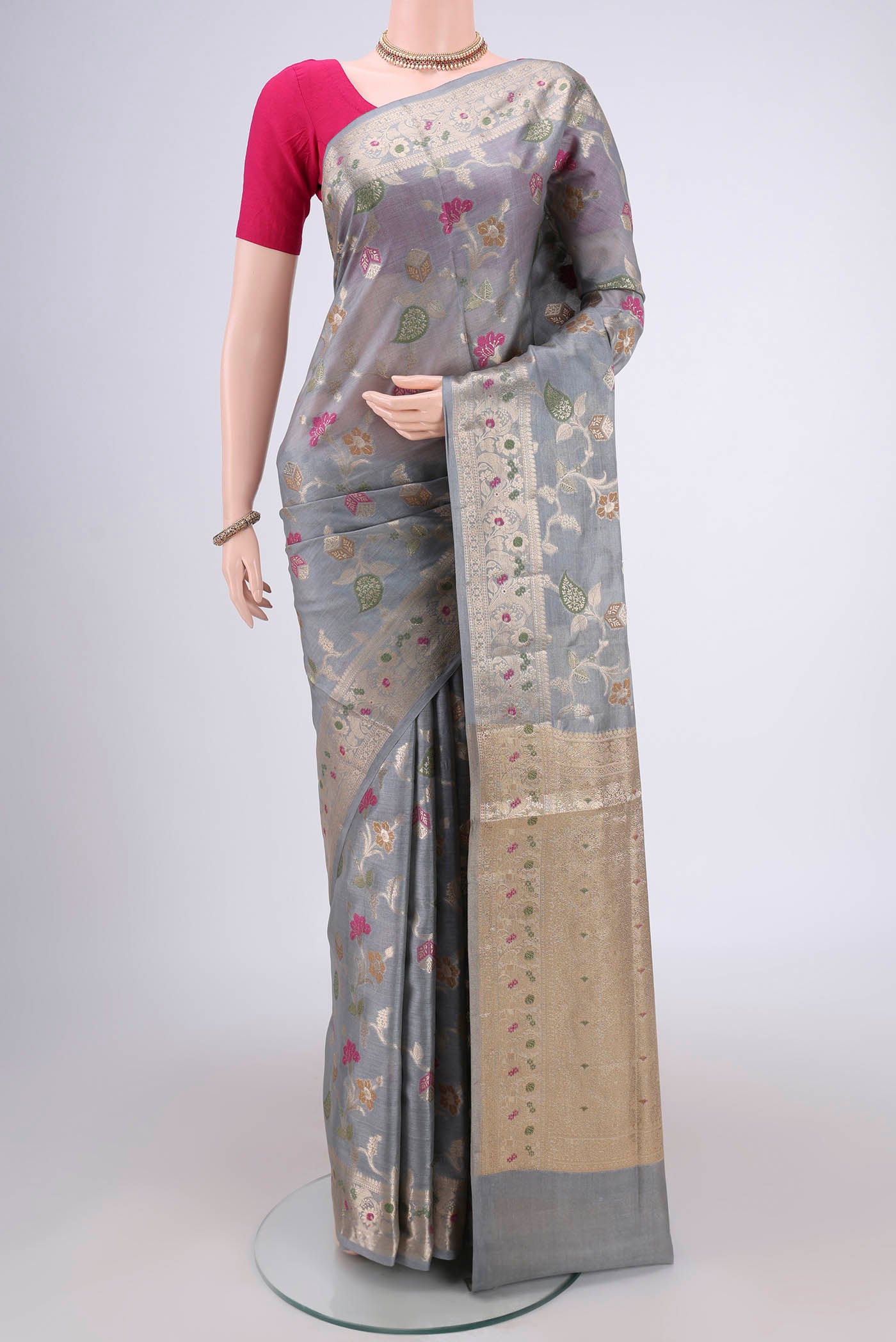 Grey Banarasi Tussar Silk Saree with Zari And Thread Butta on the body and Zari And Thread Border.  displayed on a mannequin