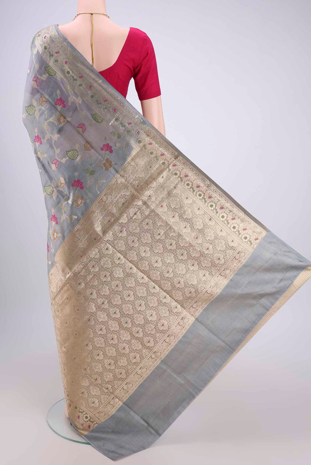 Flat view of Grey Banarasi Tussar Silk Saree with Zari And Thread Butta on the body and Zari And Thread Border. 