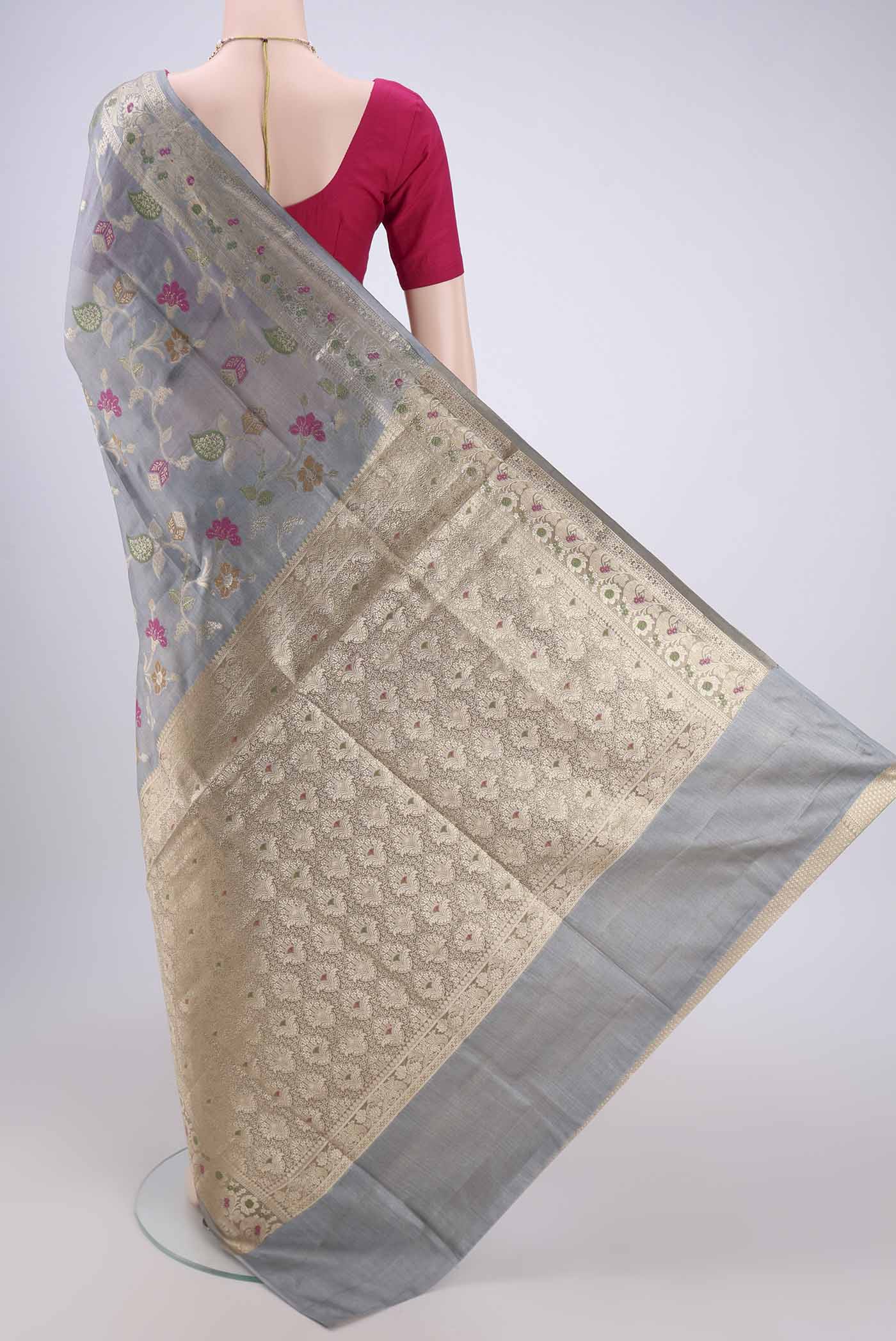 Flat view of Grey Banarasi Tussar Silk Saree with Zari And Thread Butta on the body and Zari And Thread Border. 