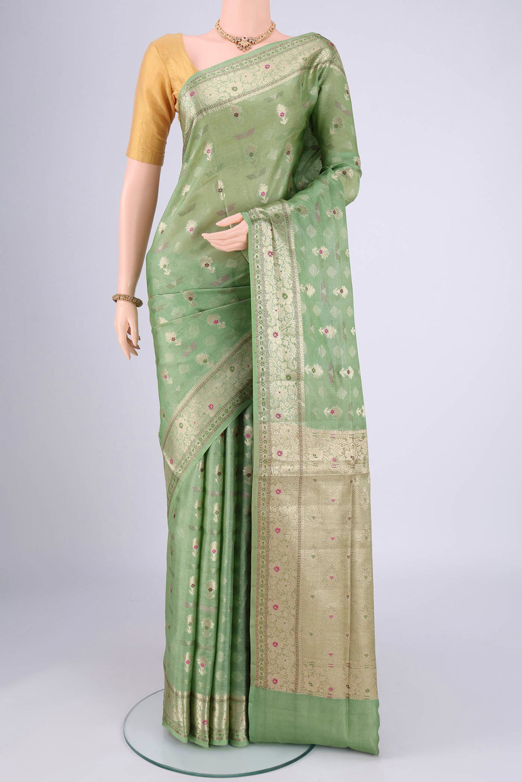 Light Green Banarasi Tussar Silk Saree with Zari And Thread Butta on the body and Zari And Thread Border.  displayed on a mannequin