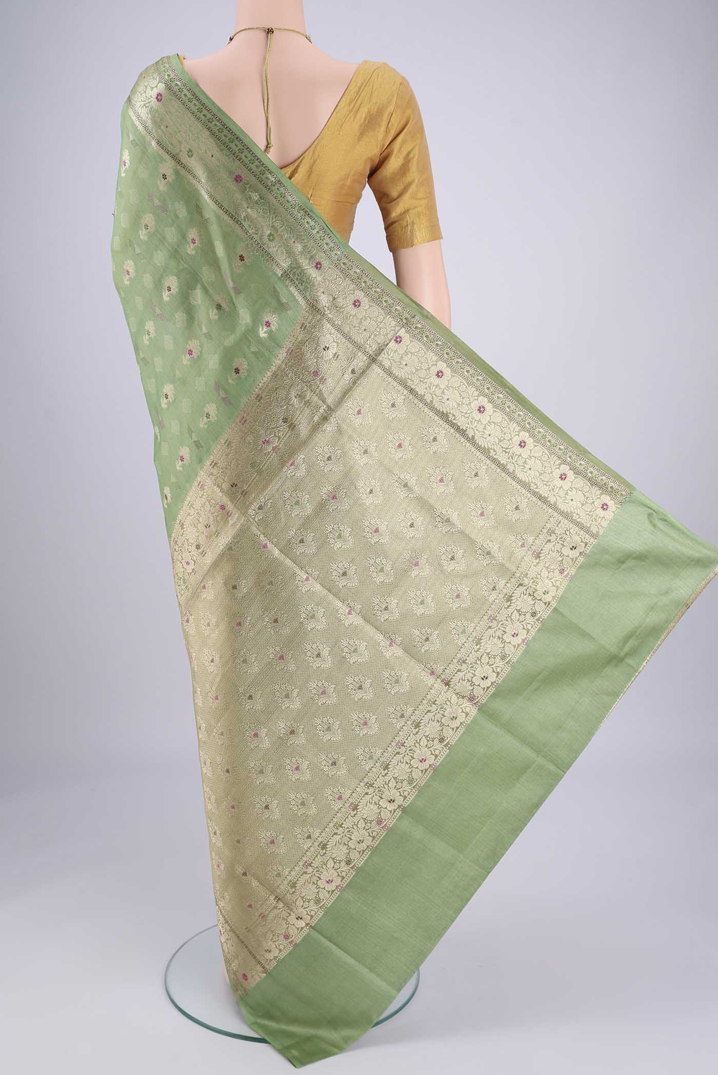 Flat view of Light Green Banarasi Tussar Silk Saree with Zari And Thread Butta on the body and Zari And Thread Border. 