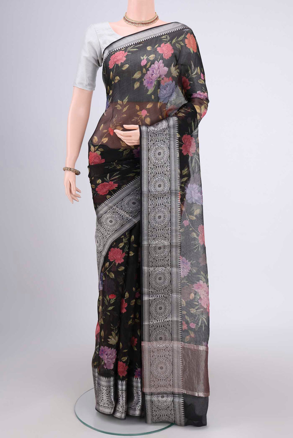 Black Kota Silk Saree with Floral Print on the body and Zari Border.  displayed on a mannequin