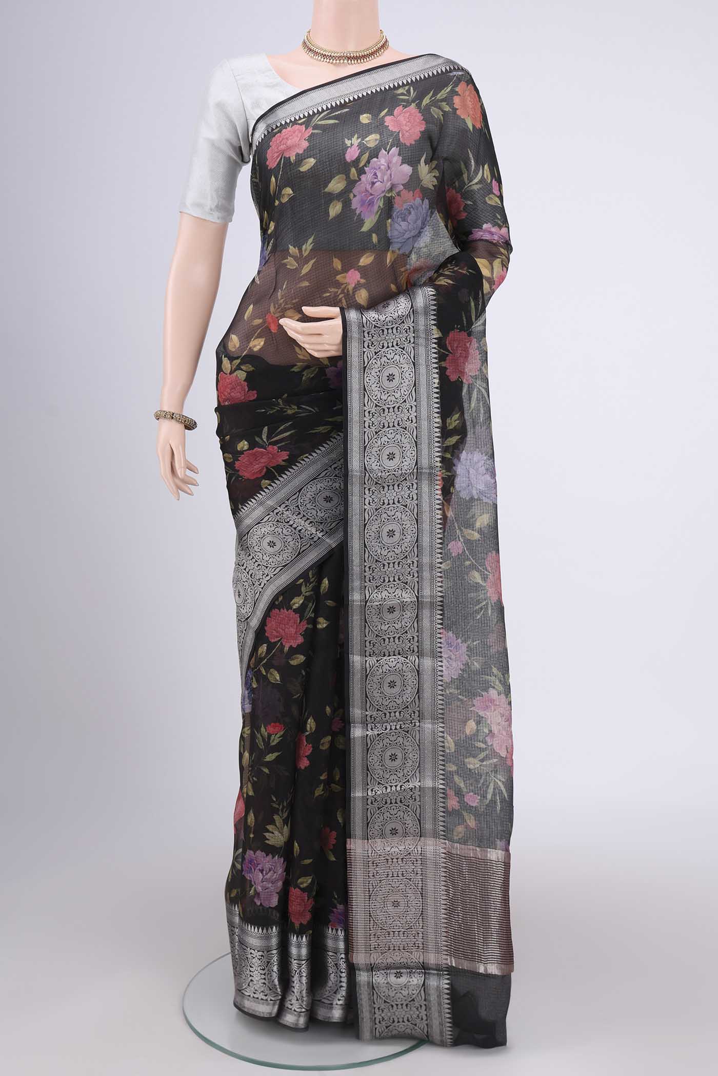 Black Kota Silk Saree with Floral Print on the body and Zari Border.  displayed on a mannequin