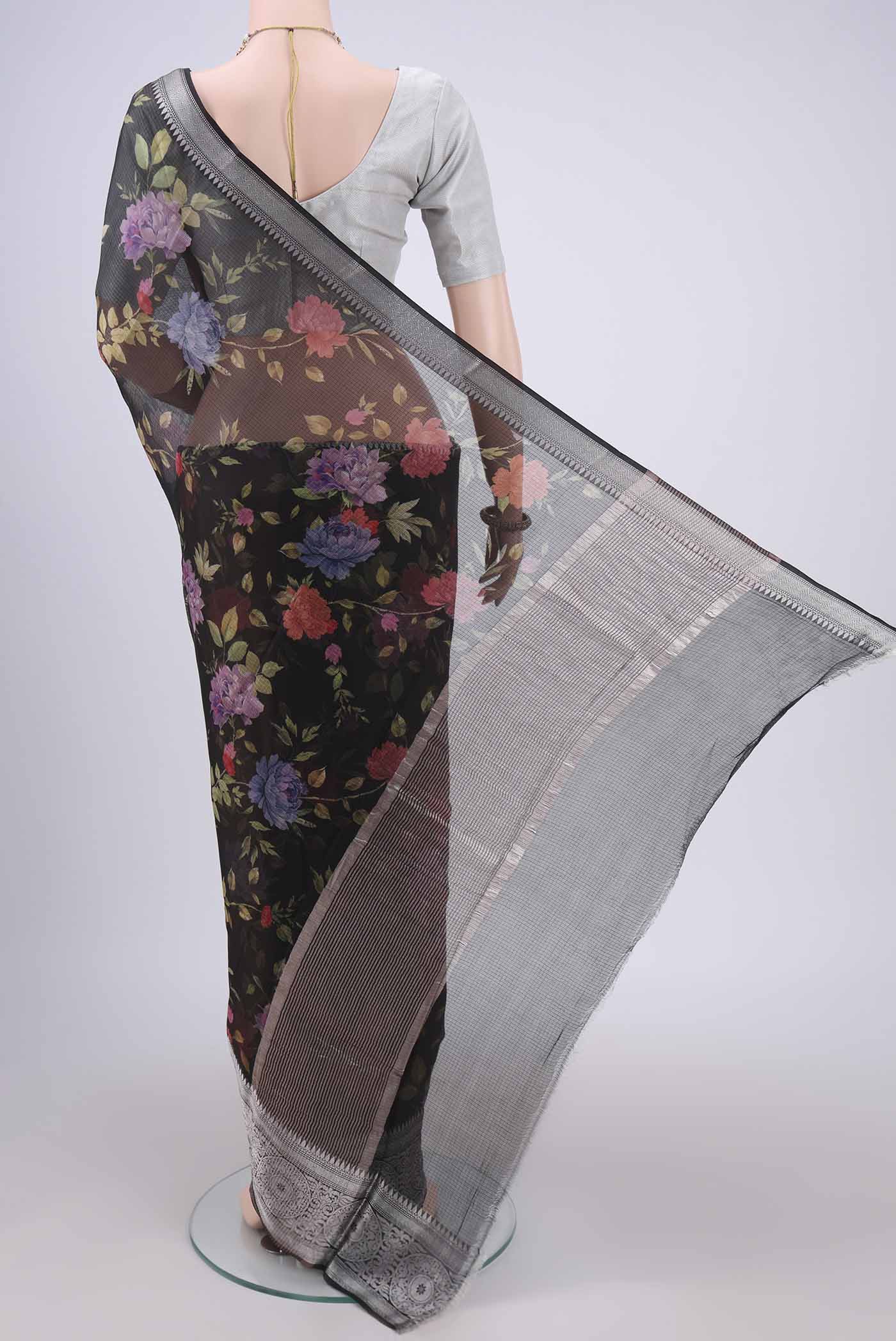 Flat view of Black Kota Silk Saree with Floral Print on the body and Zari Border. 