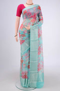 Turquoise Kota Silk Saree with Floral Print on the body and Zari Border.  displayed on a mannequin