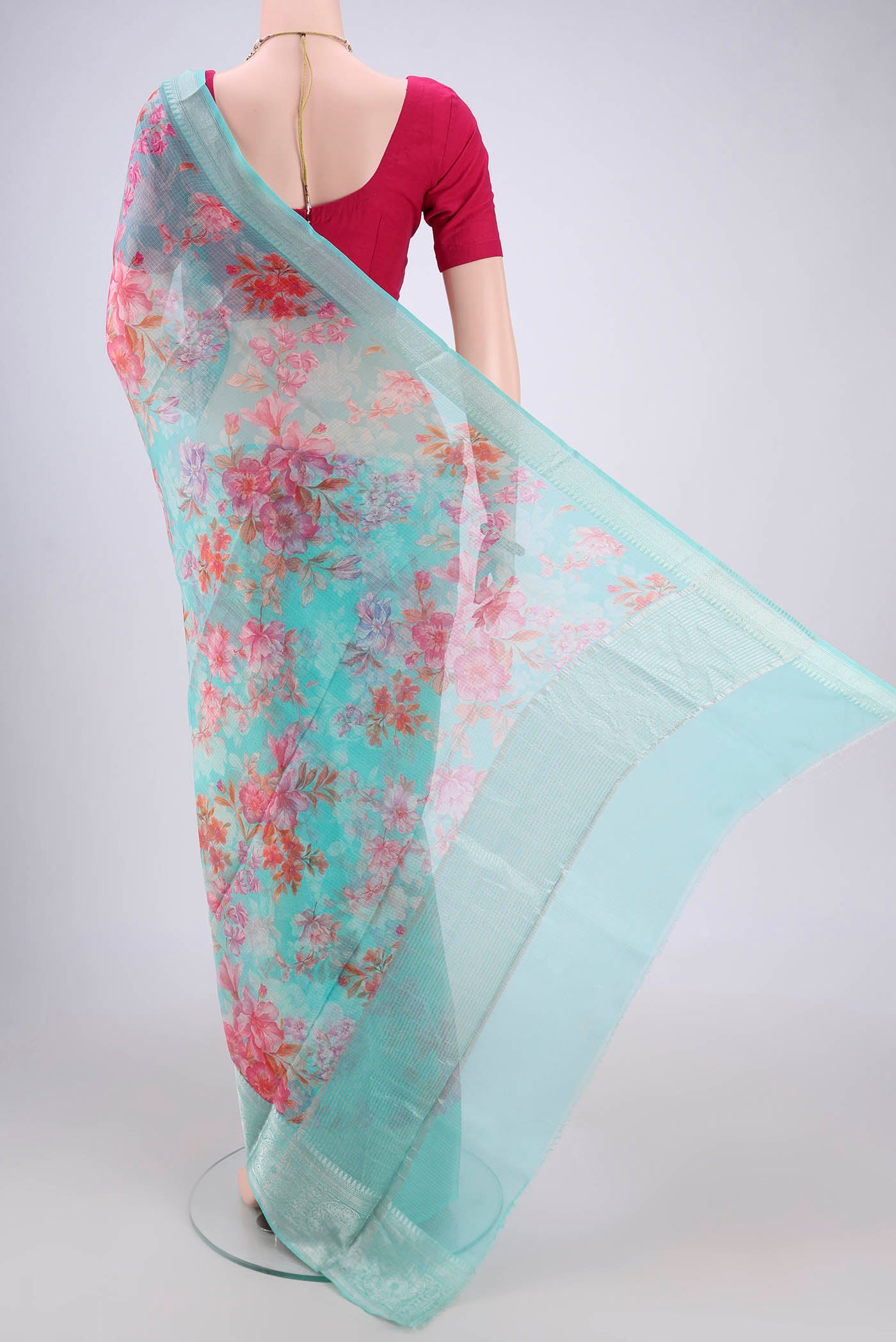 Flat view of Turquoise Kota Silk Saree with Floral Print on the body and Zari Border. 