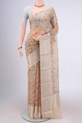 Beige Kota Silk Saree with Floral Print on the body and Zari Border.  displayed on a mannequin