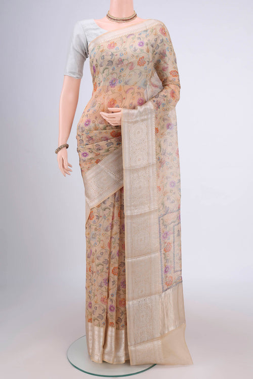 Beige Kota Silk Saree with Floral Print on the body and Zari Border.  displayed on a mannequin