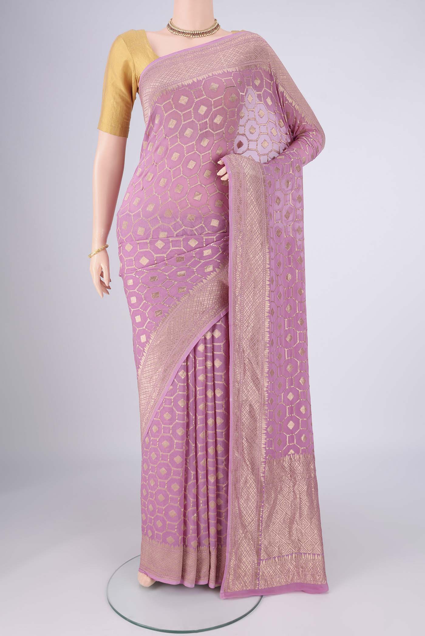 Lilac Banarasi Georgette Saree with Zari Brocade on the body and Zari Border.  displayed on a mannequin