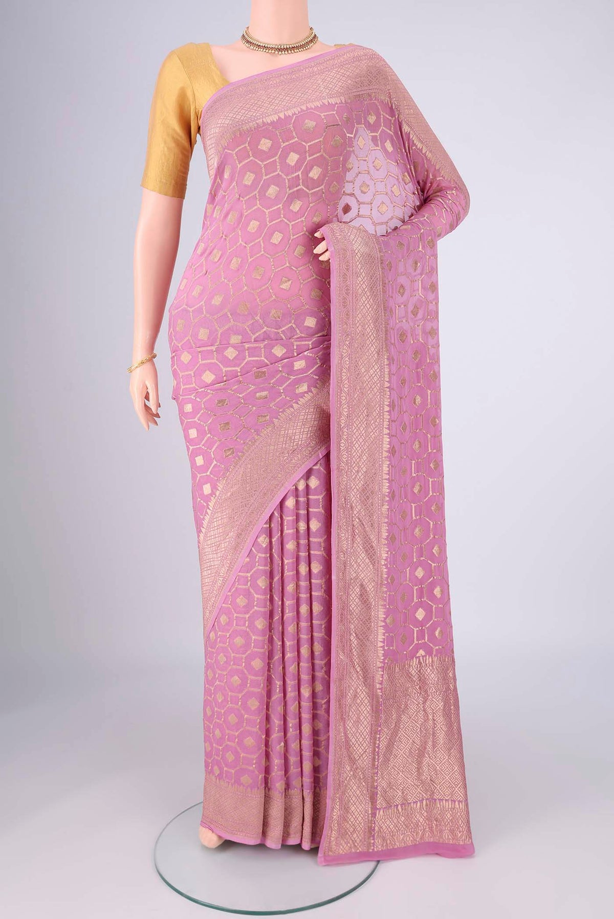 Lilac Banarasi Georgette Saree with Zari Brocade on the body and Zari Border.  displayed on a mannequin