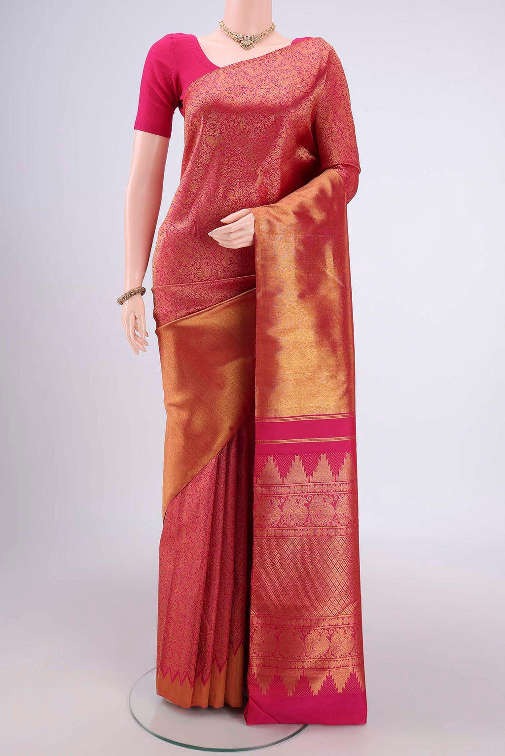 Rani Pink Dual Tone Kanchipuram Silk Saree with Half And Half on the body and Temple Border.  displayed on a mannequin