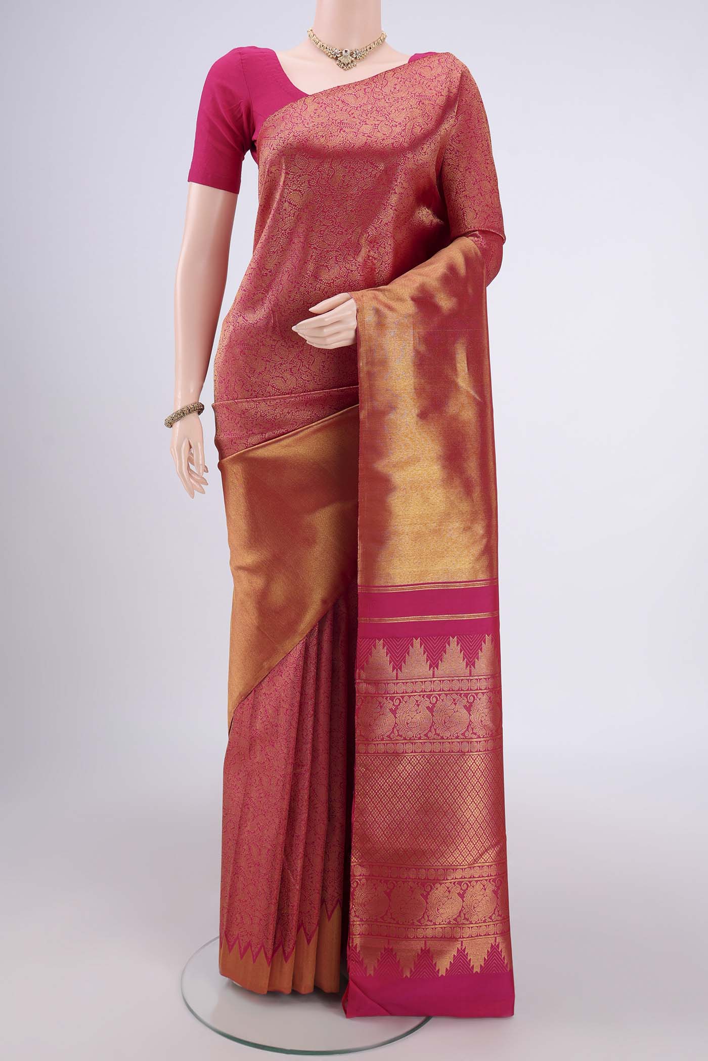 Rani Pink Dual Tone Kanchipuram Silk Saree with Half And Half on the body and Temple Border.  displayed on a mannequin
