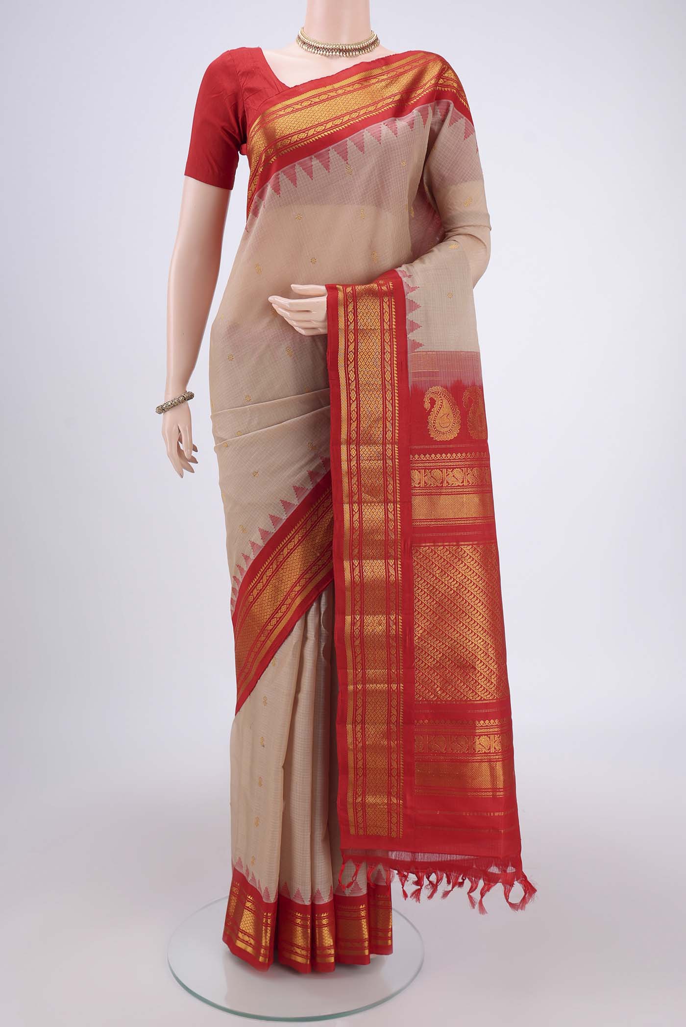 Beige Gadwal Silk Saree with Zari Butta on the body and Zari Border.  displayed on a mannequin