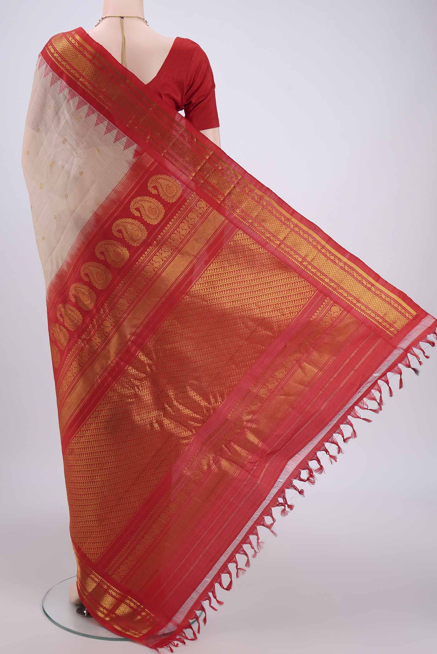 Flat view of Beige Gadwal Silk Saree with Zari Butta on the body and Zari Border. 