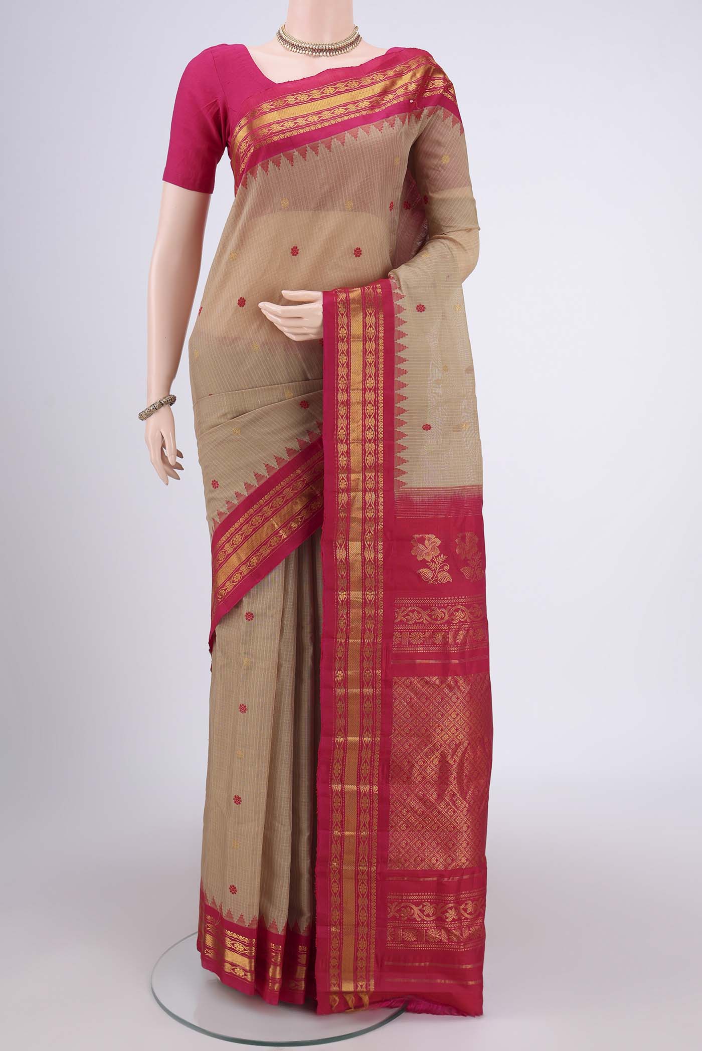 Beige Gadwal Silk Saree with Zari And Thread Butta on the body and Zari Border.  displayed on a mannequin